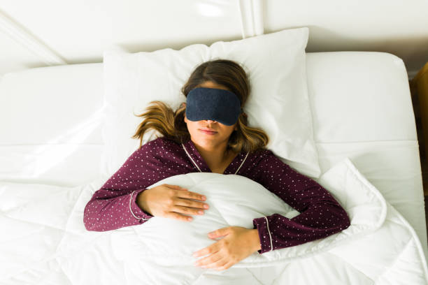 istock Tired woman with a sleep mask 1356414593