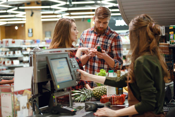 istock Concentrated young couple standing in supermarket 1356414944