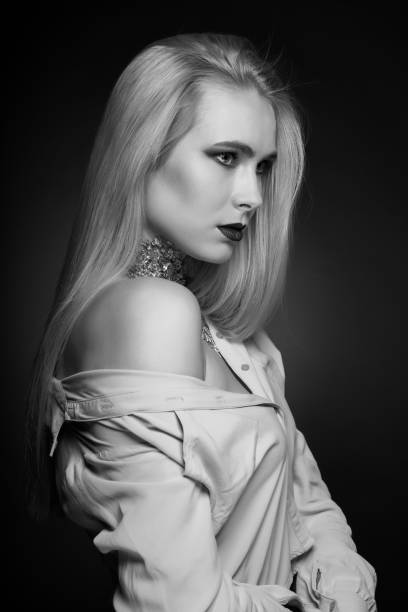 istock Monochrome beauty shoot: alluring blond model posing with foil on her neck 1356415166