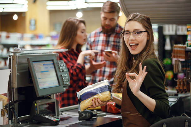 istock Cashier woman on workspace make okay gesture. 1356415214