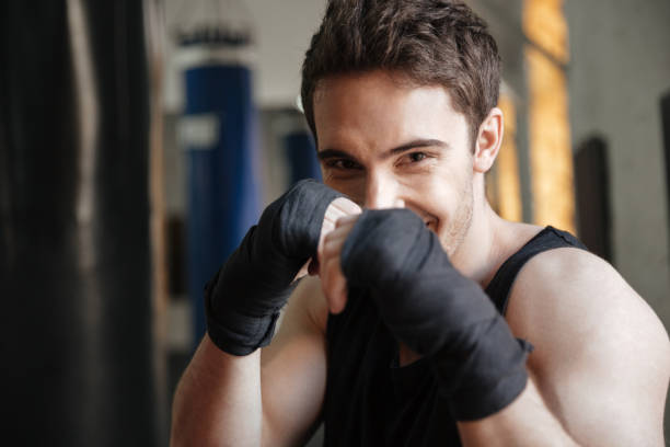 istock Close up  view of smiling boxer doing exercise in gym 1356419054
