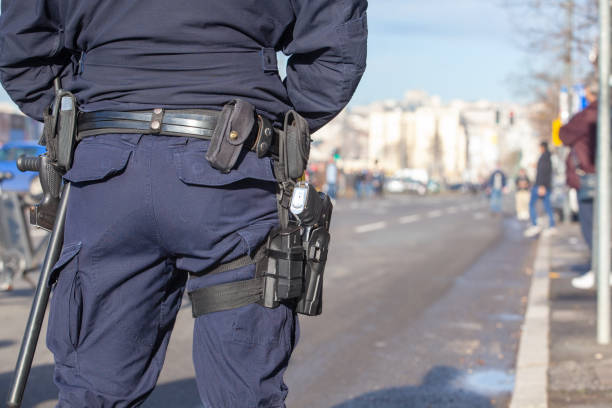 istock Police officer on duty, blurred people in the background 1356420234