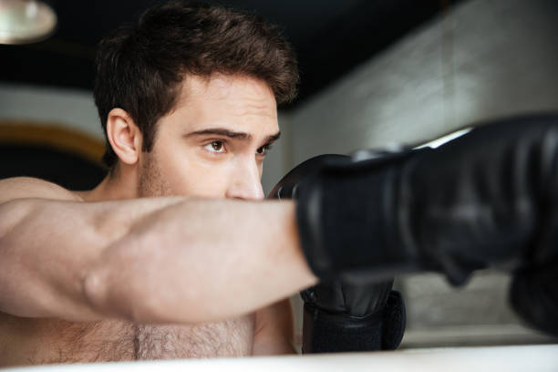istock Portraitof strong attentive boxer making kick 1356420496