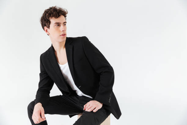 istock Man in suit sitting on box and looking away 1356421445