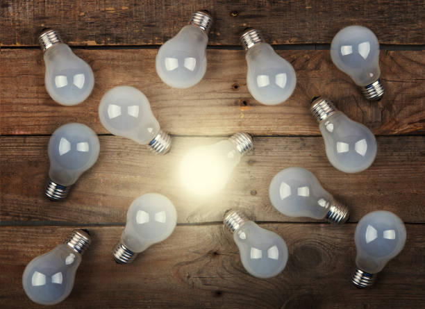 istock Vintage bulbs on wooden background - idea, innovation, teamwork and leadership concept. Space for text 1356421676