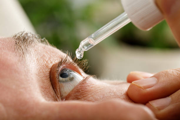 istock A man moistens his eyes before installing contact lenses. Drops in the eyes from irritation, redness and allergies 1356423090