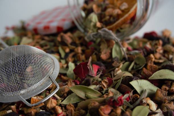 istock a heap of dried mixed herbs and fruit, herbal tea ingredient with strainer and bottle and colorful cover 1356423091