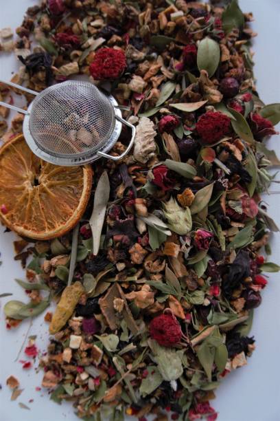 istock a heap of dried mixed herbs and fruit, herbal tea ingredient with strainer 1356423107