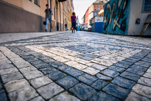 A mosaic of granite paving stones on one of Prague's streets . Czech Republic, Prague end of july 2021.