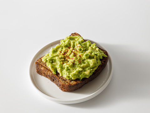 Mashed avocado toasts on plate. Concept of healthy eating, dieting, vegan vegetarian food