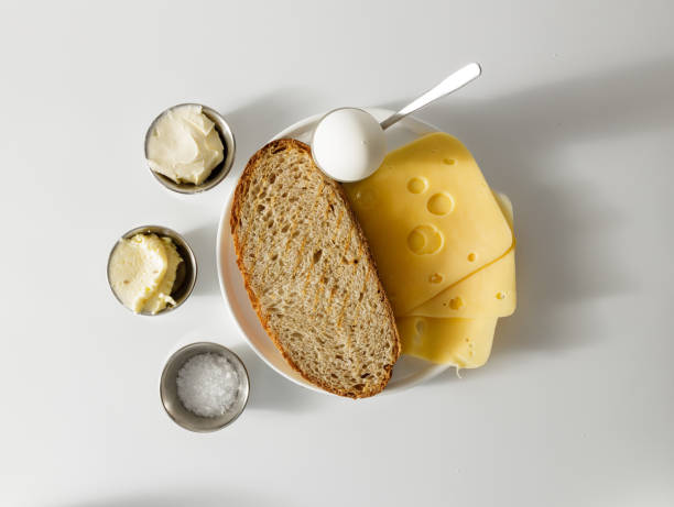 Top view of food for breakfast on white plate Healthy meals for eating. Sous, salt and hard boiled egg in bowl. Bread with cheese granary toast stock pictures, royalty-free photos & images