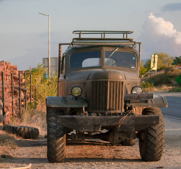 istock Foreside of a truck oldtimer near a log yard. 1356425184