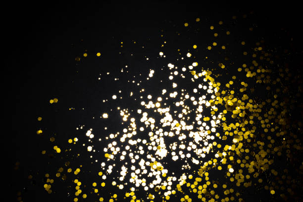 istock Golden glitter sequins isolated on black background. 1356426754