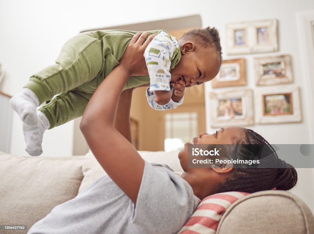 Shot of a young woman bonding with her baby at home I love spending time with my baby Baby - Human Age Stock Photo