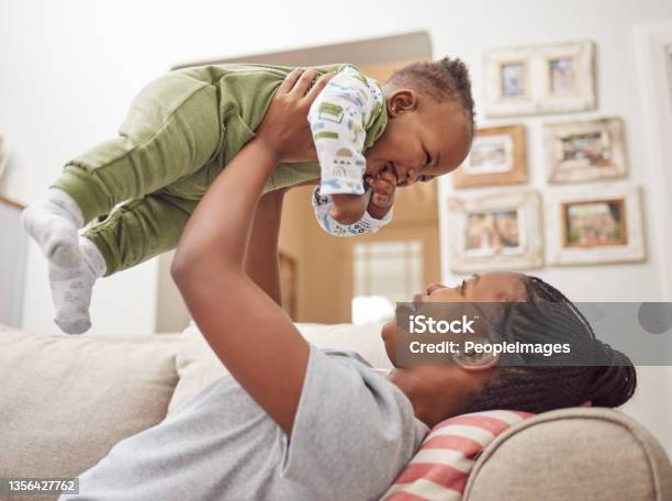 Shot Of A Young Woman Bonding With Her Baby At Home Stock Photo - Download Image Now