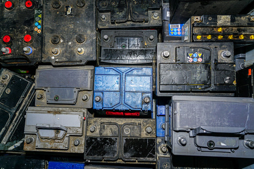 top view of many used car batteries waiting to be recycled in an environmentally harmful scrap yard