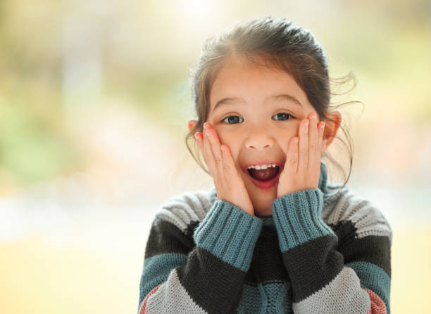 shot of an adorable little girl at home - surprise child little girls shock imagens e fotografias de stock