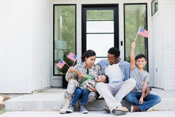 Female soldier is excited to be home with her family stock photo