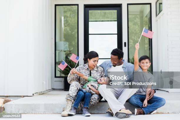 Female Soldier Is Excited To Be Home With Her Family Stock Photo - Download Image Now