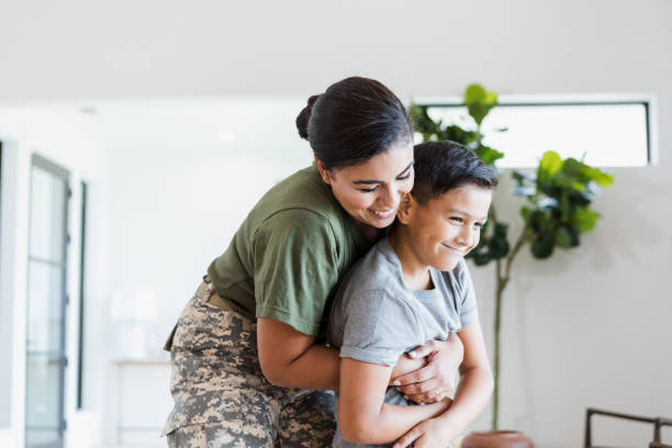 istock Female soldier gives son a hug 1356430757