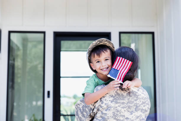 istock Cheerful boy happy for mom's return from military assignment 1356430803