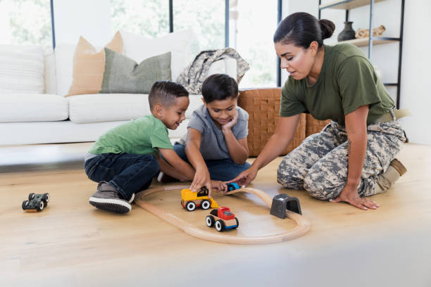 istock Before work, soldier mom plays on floor with sons 1356430935