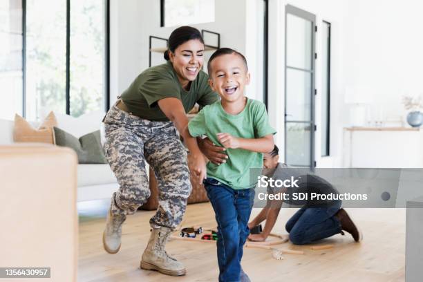 After Work Female Soldier Chases Son In House Stock Photo - Download Image Now - Family, Military, Veteran