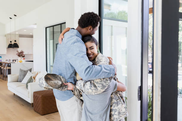 istock Happy soldier mom hugs family after deployment 1356430978
