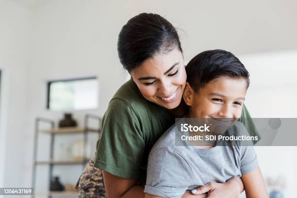 Soldier Mom Gives Preteen Son Big Hug Stock Photo - Download Image Now - Family, Mother, Child
