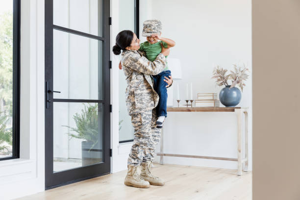 istock Before work, female soldier picks up young son 1356431218