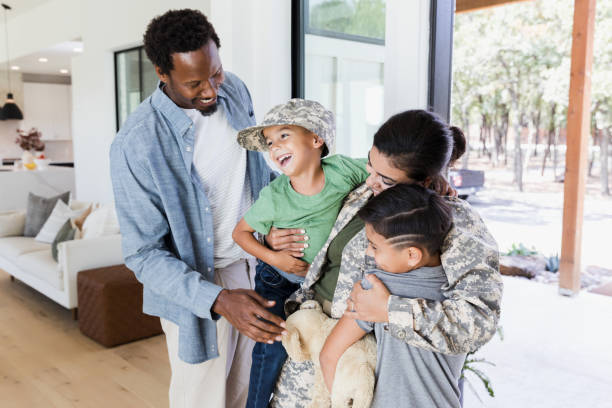 istock Soldier mom hugs sons after deployment 1356431219