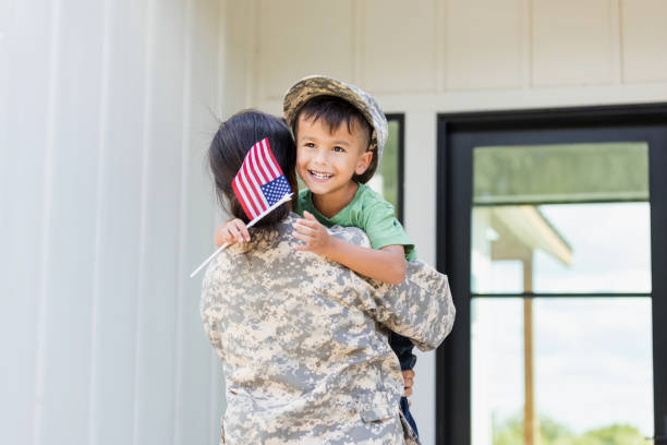 istock Soldier mom embraces young son after deployment 1356431238