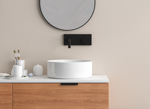 Close up of sink with oval mirror standing in on beige wall , wooden cabinet with black faucet in minimalist bathroom.Front view. 3d rendering