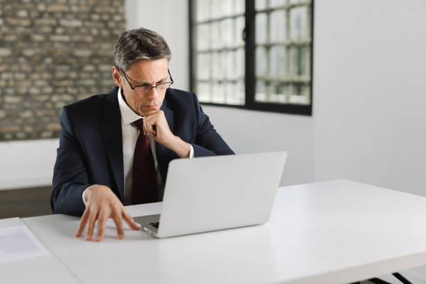 istock Thoughtful businessman working on a computer in the office 1356431665