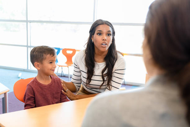 istock Mid adult mom and unrecognizable teacher discuss boy's behavior 1356433394