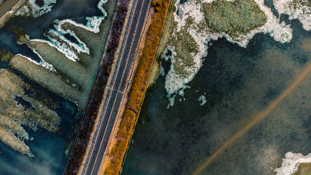 istock Railway track through frozen floodplain 1356434157