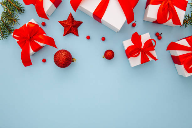 istock Christmas composition, gifts, fir tree branches, red decorations on blue background, winter, new year concept, flat lay, copy space 1356435311