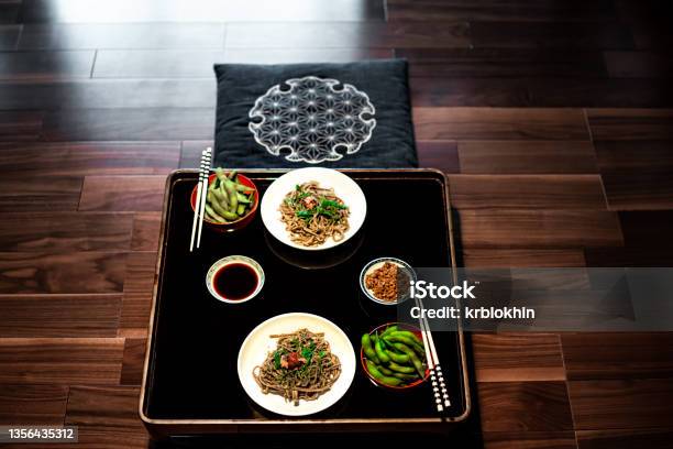 Traditional Japanese Restaurant Ryokan Kaiseki With Food Dish Of Boiled Edamame Natto And Soy Sauce On Plate By Chopsticks And Soba Buckwheat Noodles Above High Angle View Nobody Stock Photo - Download Image Now