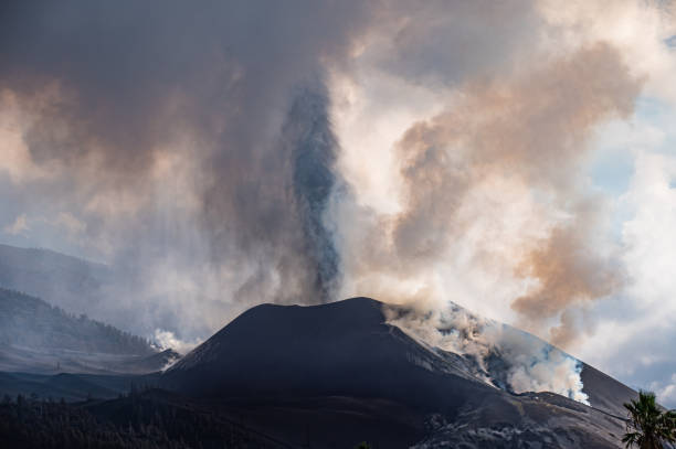 istock Active volcano with thick smoke erupting in daytime 1356435720