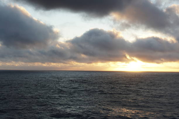 istock Sunset over the Atlantic Ocean with slight waves under the woolpack cumulus clouds. 1356436006