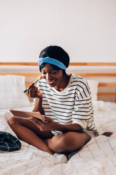 istock Happy Woman Doing Makeup in the Morning 1356438225