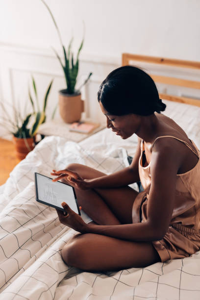 istock Beautiful Woman Using Digital Tablet in her Bed 1356438234