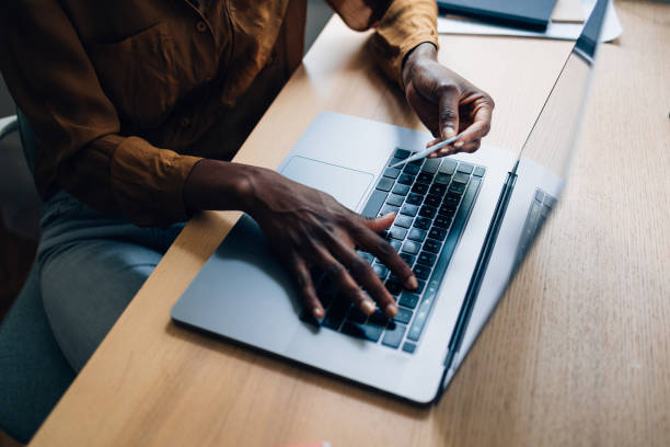 istock An Anonymous Business Woman Making a Credit Card Purchase 1356438298
