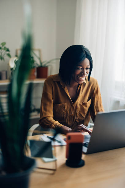 istock Happy Business Woman Working from Home on Laptop Computer 1356438302