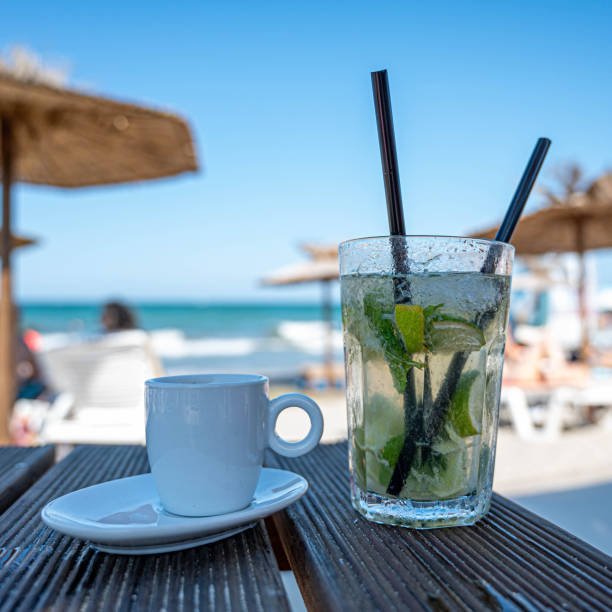 istock Cold mojito and coffee on the table in the sunny beach 1356438673