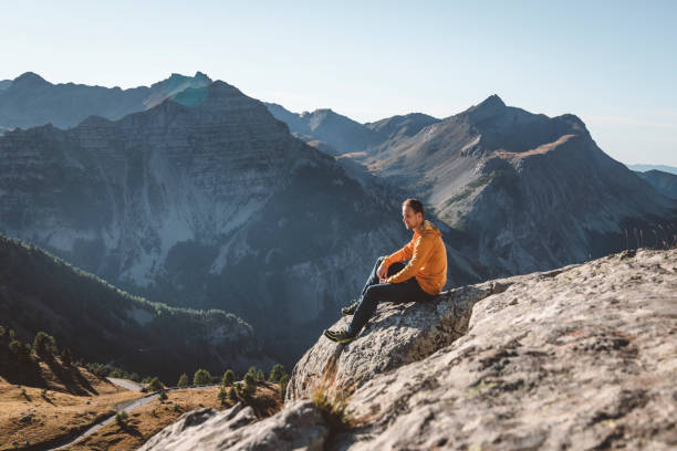 istock Man resting on the rock, France 1356438991