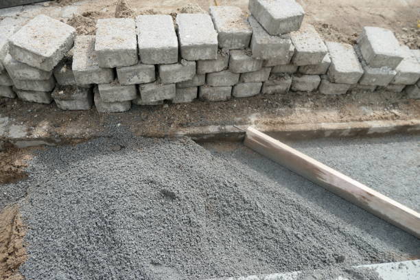 istock Rectangular paving stones are being re-laid on a sidewalk in a pedestrian zone in Hamburg, Germany. Close up 1356440018