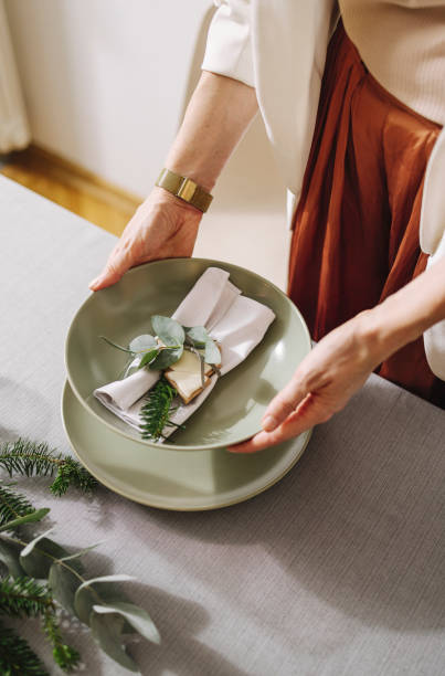 istock Christmas Celebration: An Anonymous Woman Setting Up Christmas Dinner Table 1356441066