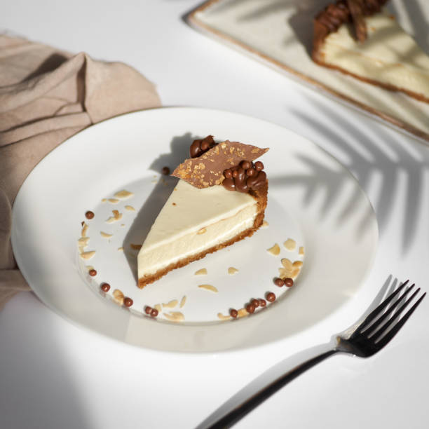 istock Sliced Cheesecake. Layer of biscuits, mousse based on creamcheese, with chocolate cream. Healthy dessert. 1356442400