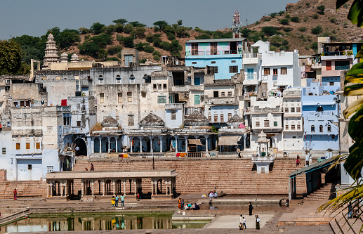 Pushkar, India - oct 23, 2011: the white houses and many of Pushcar's temples overlook the ghats from which pilgrims perform sacred ablutions into the lake.